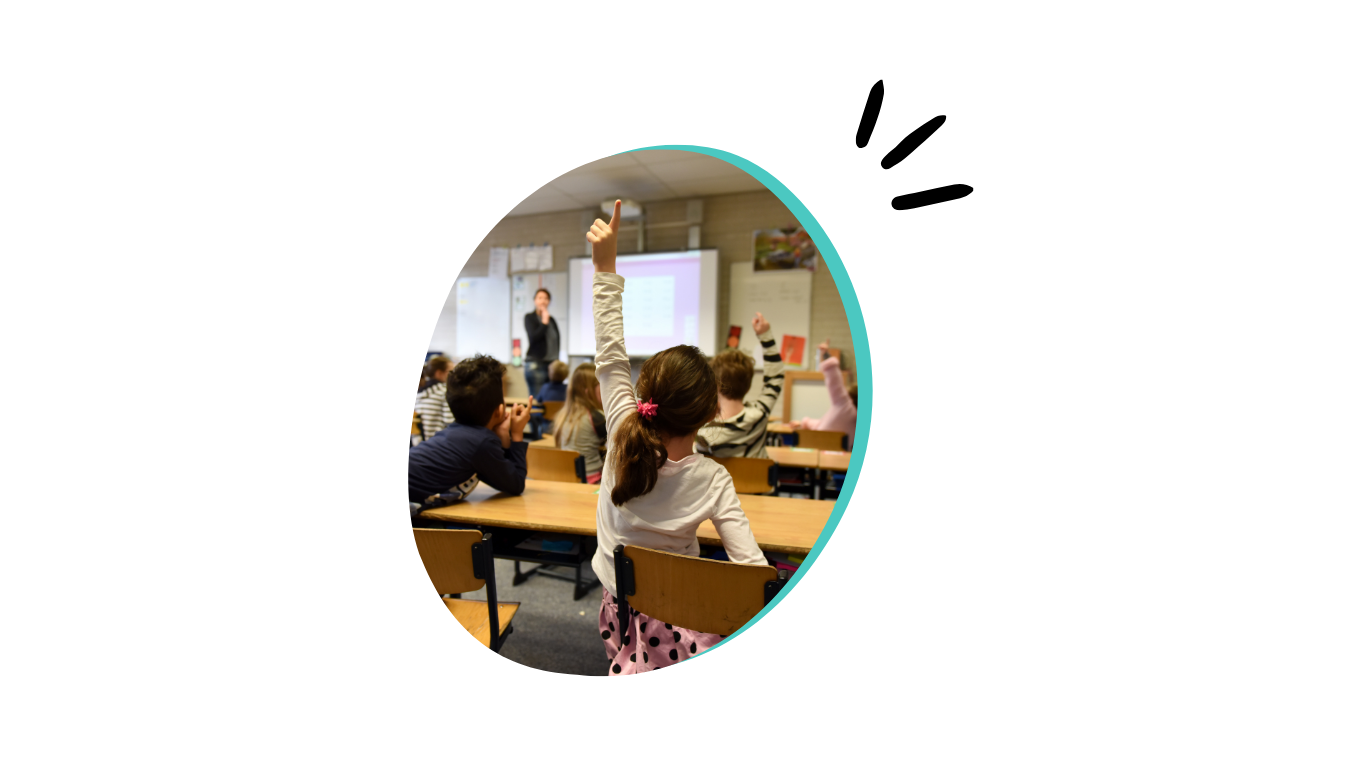 7 children in a classroom putting their hands up