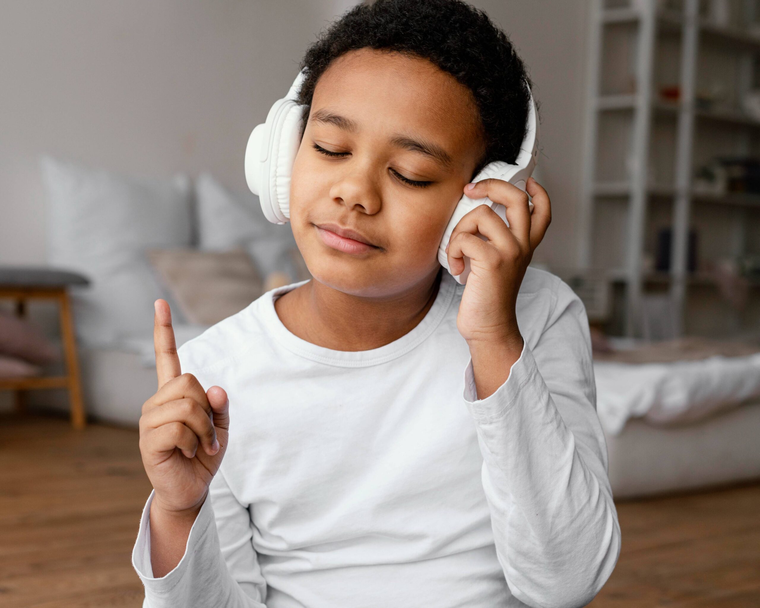 a little boy wearing headphones closing his eyes listening to music