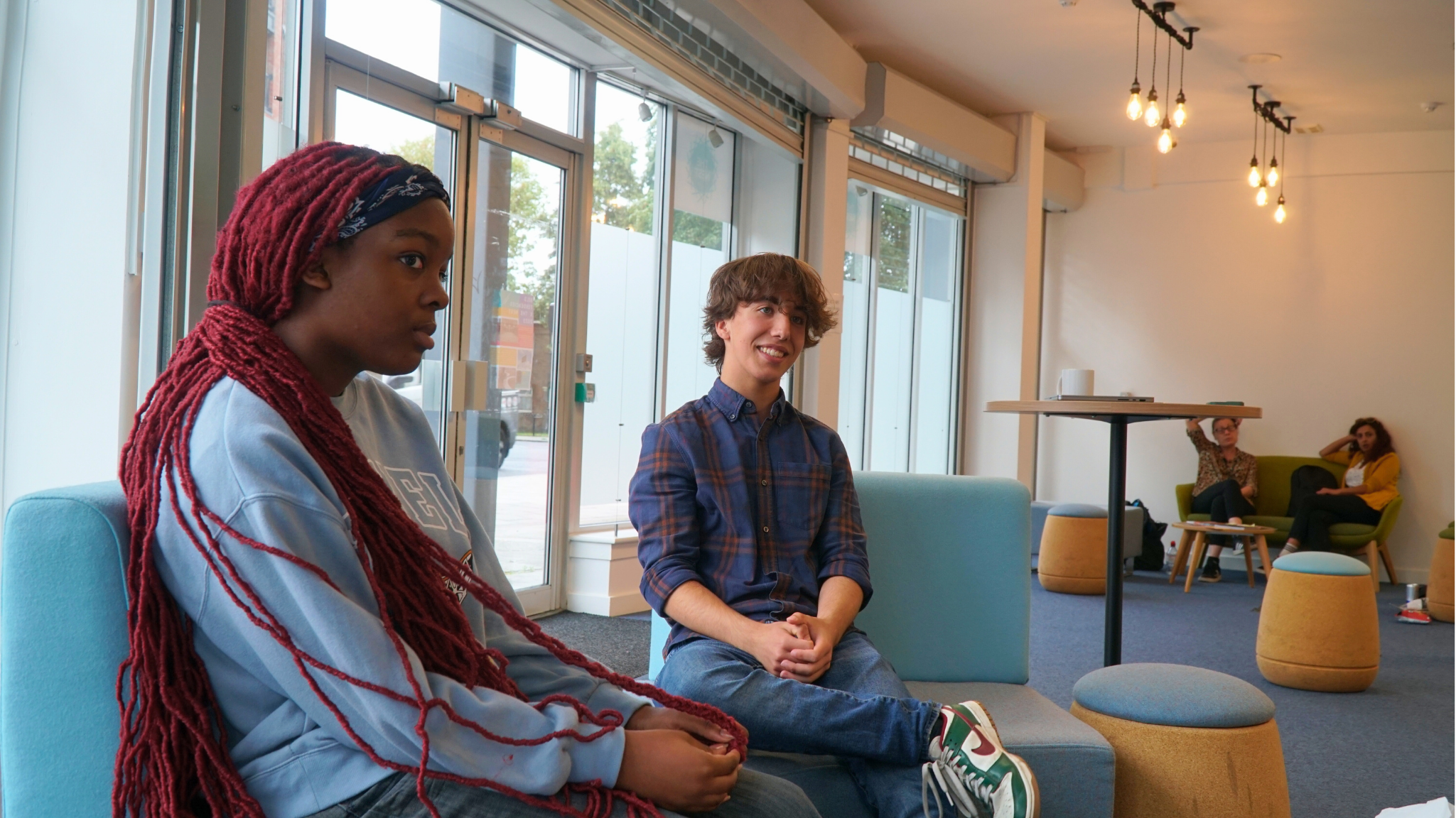 two young people sitting in the nest